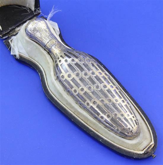 A cased late 19th/early 20th century French silver gilt overlaid glass teardrop shaped scent bottle, 4.5in.